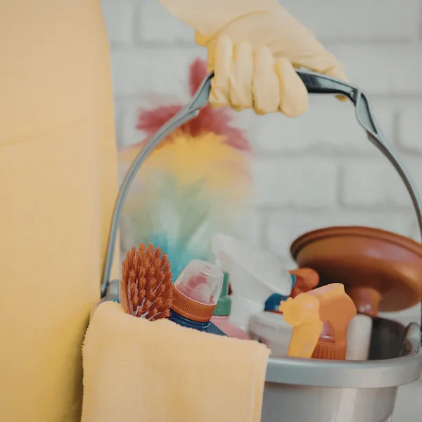 Vibrant cleaning supplies bucket with tools and agents for effective household cleaning tasks.