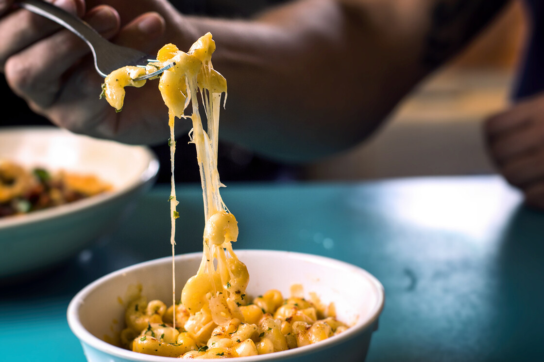 Eating A Bowl Of Macaroni And Cheese